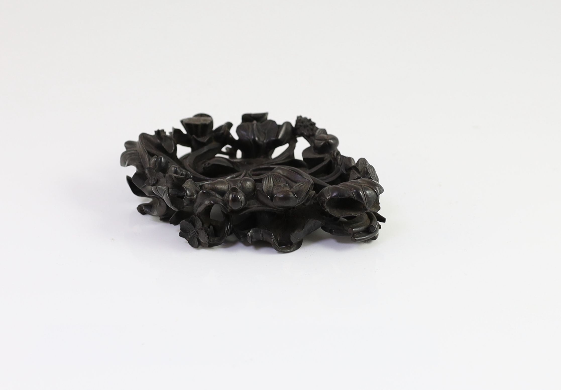 A fine Chinese carved zitan ‘lotus’ stand, Qing dynasty, 14.5cm long, small losses